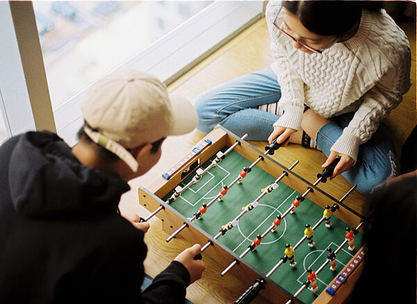 Jugendliche spielen Kicker
